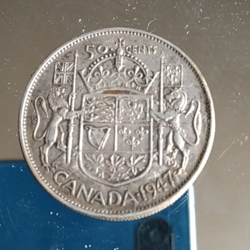 1947, curved 7(maple leaf)50¢ silver